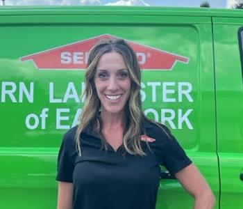 Amy Levin in front of SERVPRO van