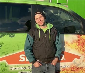 John standing in front of servpro van