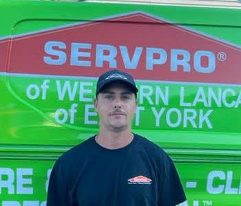 Ron Bentzel in front of SERVPRO van