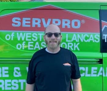 Joe Cunningham in front of SERVPRO van